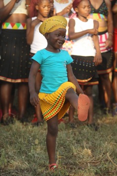 A young Zulu girl performing a traditional dance